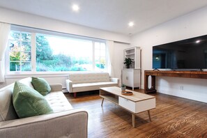 A modern living room with a sofa, coffee table, and a television.
