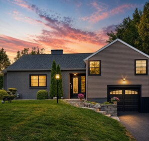 A two-story house with a dark roof, a front porch, and a garage. - Boutique Studio, Private Hot tub (Fayetteville)