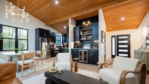 A modern kitchen with dark cabinets, stainless steel appliances, and a built-in oven. - New listing! 4BR Holland Getaway Near Lake Michigan Beaches & Kirk Park (West Olive)