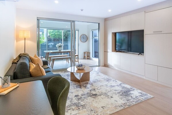 A modern living room with a sofa, coffee table, and TV.