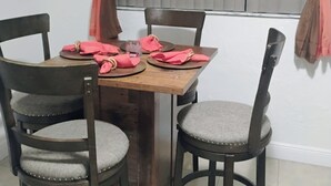 A dining table with four chairs, a TV mounted on the wall, and curtains on the windows. - WALKING DISTANCE FROM HARD ROCK STADIUM
1-bedroom apartment Miami Gardens (Miami Gardens)