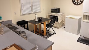 A compact kitchen with a microwave, toaster, and sink. - Welcoming 2-bedroom basement apartment with AC in vibrant Atlanta (Atlanta)