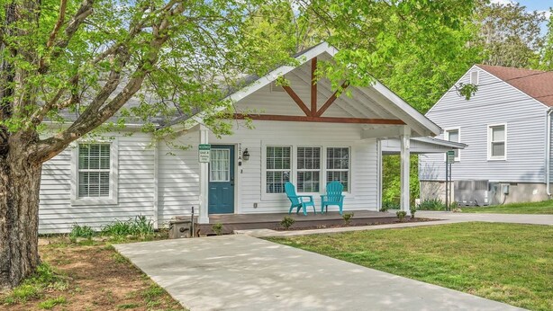 A single-story house with a porch, a front door, and two windows. - Cozy 2 Bedroom 1 Bath home in the heart of Clarksville (Clarksville)