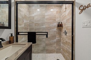 A bathroom with a shower, a sink, and a towel rack. -   Modern 3BR Home Patio Near Center City Free Parkin (Philadelphia)