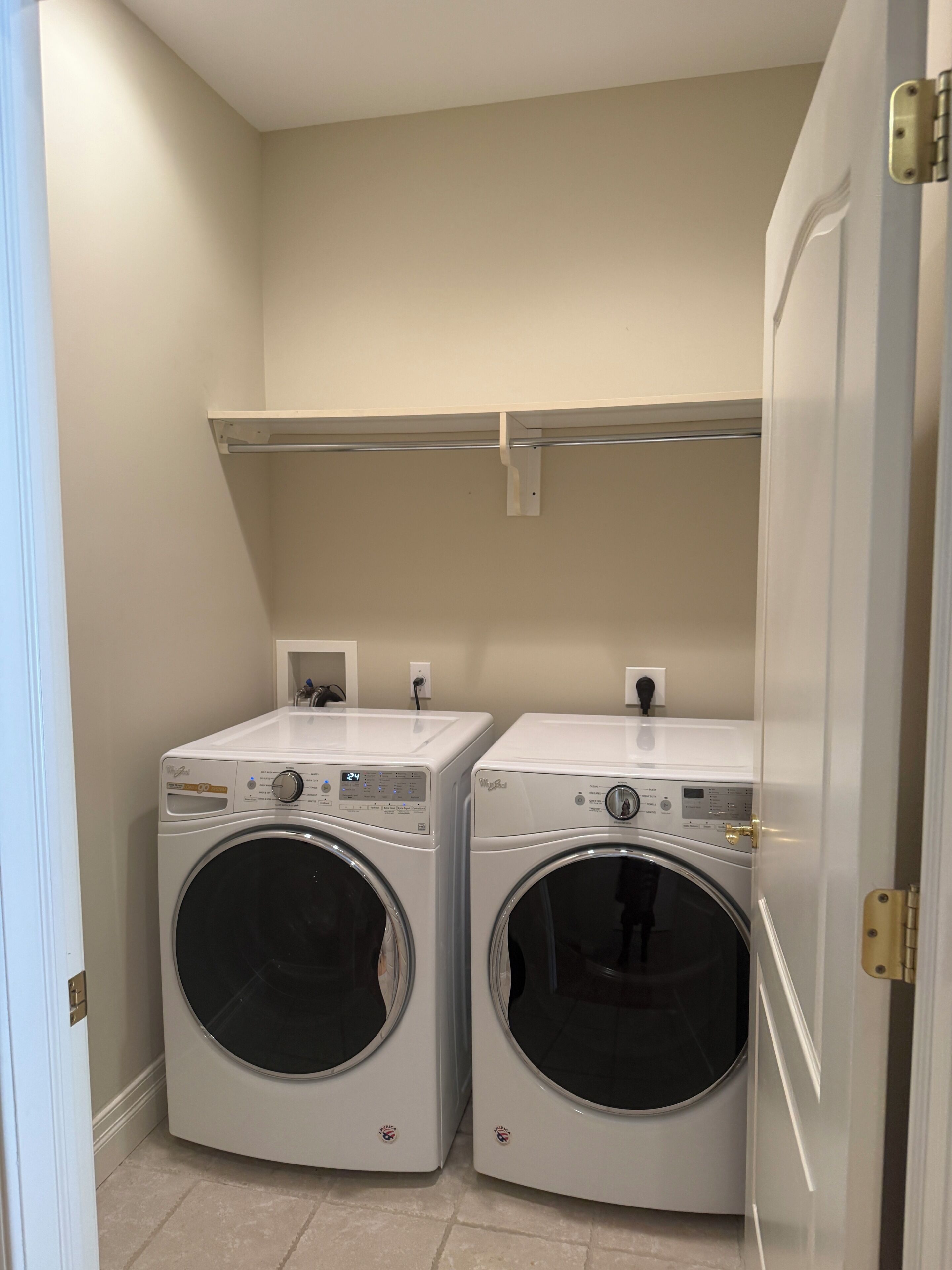 Fully stocked Laundry room with washer and dryer. 