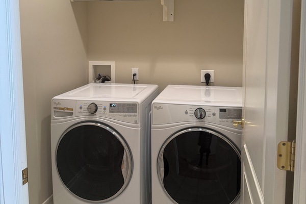 Fully stocked Laundry room with washer and dryer.