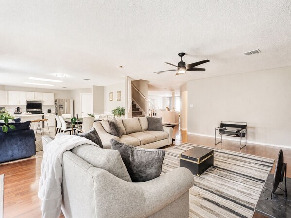 A modern living room with a sofa, a coffee table, and a TV stand.