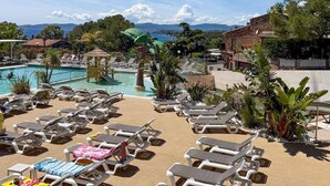 Ein Poolbereich mit Liegestühlen und einer kleinen Laube.
