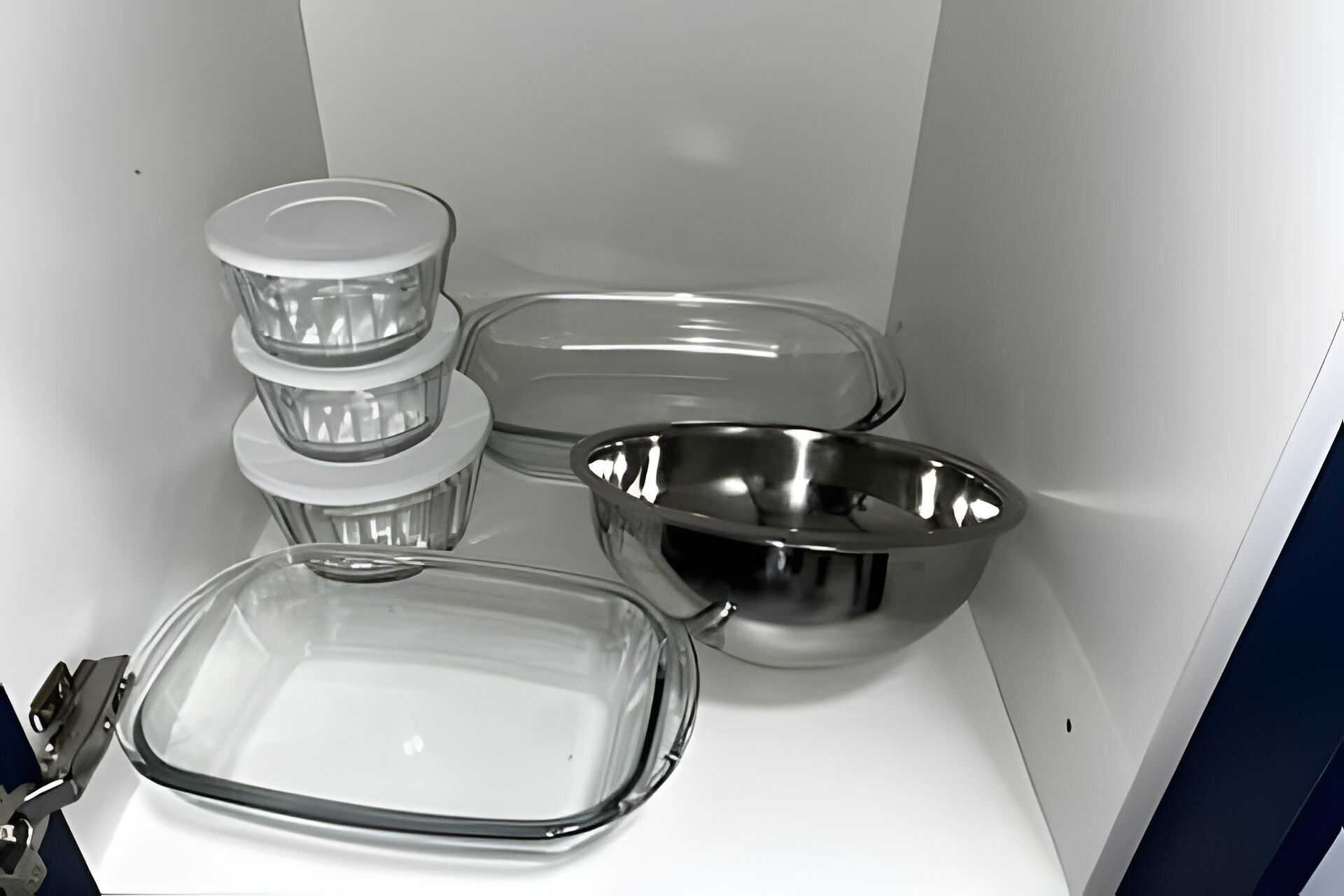 A kitchen with stainless steel appliances, including a sink, a stove, and a microwave.