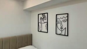 A modern room with a bed, a headboard, and two abstract art pieces on the wall. - Dajti National Park House, Sleeps 7 with AirCon (Tirane)