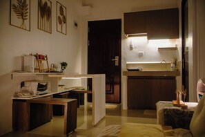 A compact kitchen with a microwave, toaster, and a small refrigerator. -  PRIME LOCATION • NEW 1BR CONDO FOR RENT (Lapu-Lapu)