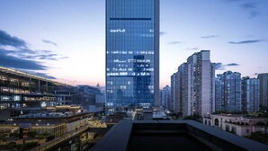 A modern high-rise building with a glass facade, surrounded by other high-rise buildings. - IntercityHotel Chongqing SKLP (Chongqing)
