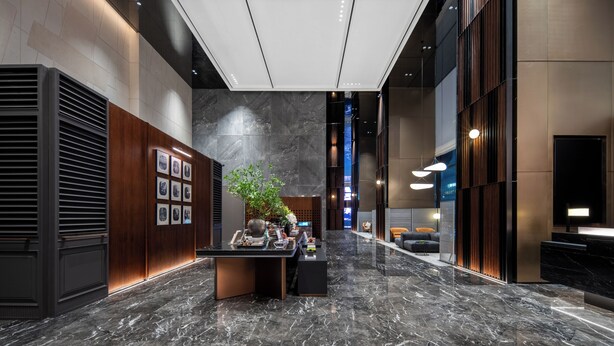 A modern lobby with a reception desk, a potted plant, and a wall with framed pictures. - IntercityHotel Chongqing SKLP (Chongqing)