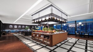 A modern hotel lobby with a central bar area, seating arrangements, and large windows offering city views. - IntercityHotel Chongqing SKLP (Chongqing)