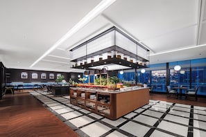 A modern hotel lobby with a central bar area, seating arrangements, and large windows offering city views. - IntercityHotel Chongqing SKLP (Chongqing)