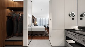 A modern hotel room with a bed, a vanity with a mirror, a walk-in closet, and a view of the city. - IntercityHotel Chongqing SKLP (Chongqing)