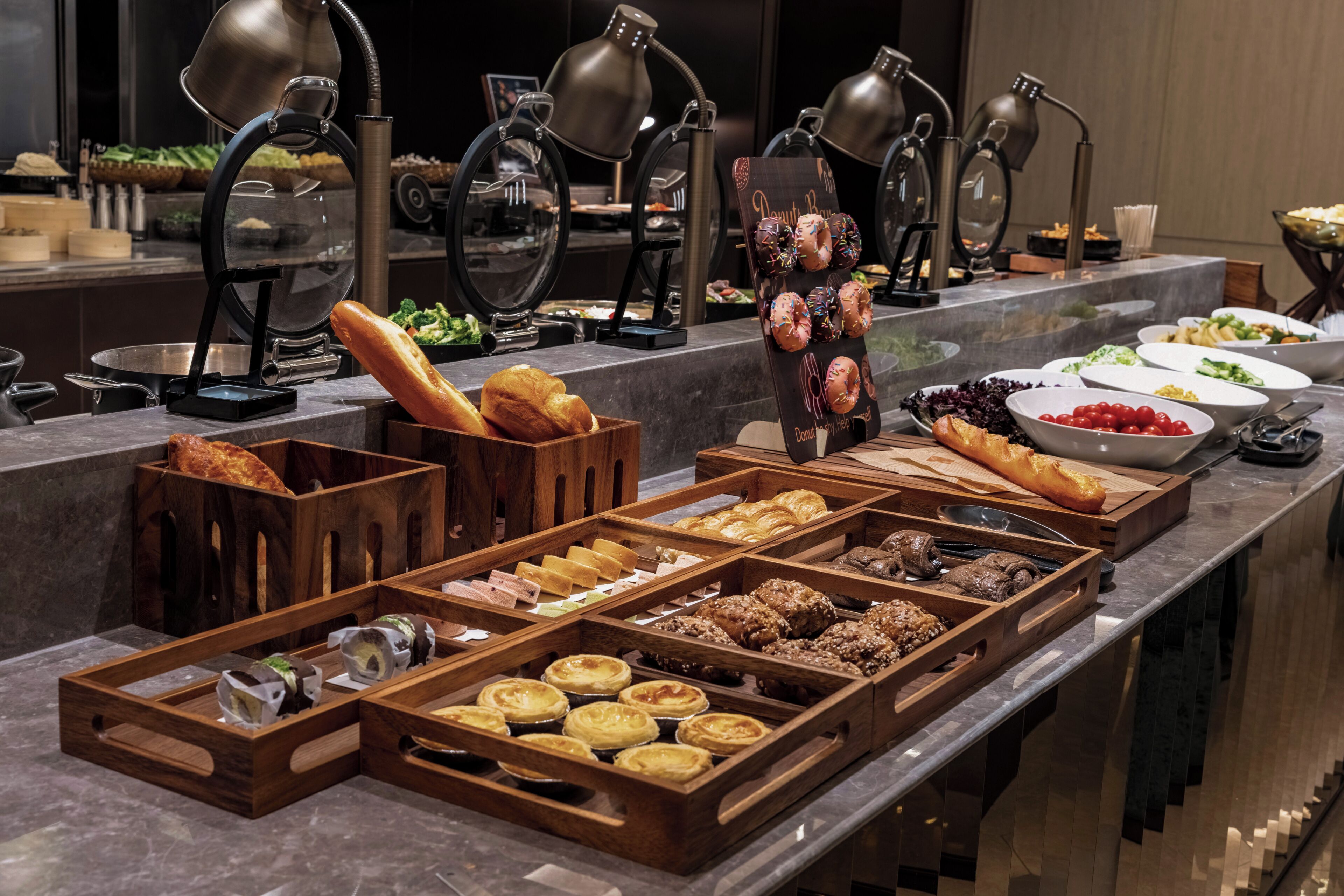A buffet with various food items and a coffee station.