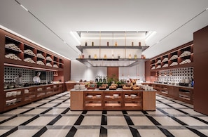 A modern kitchen with wooden cabinets, a central island, and a checkered floor. - IntercityHotel Chongqing jiangbeizui (Chongqing)