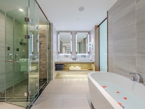 A modern bathroom with a glass-enclosed shower, a freestanding bathtub, and a vanity with a mirror. - Lavande International Baiyun Airport (Guangzhou)