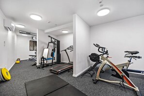 Ein Fitnessraum mit Trainingsgeräten, Laufband und Ergometer.