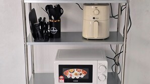 A kitchen shelf with a rice cooker, coffee maker, microwave, and utensils. - SD Homestay 81 Play Together, Fun Forever (George Town)