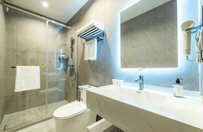 A modern bathroom with a glass shower enclosure, a toilet, a vanity with a mirror, and a hairdryer mounted on the wall. - Aifeel Hotel Beijing Capital Airport T3 (Shunyi)