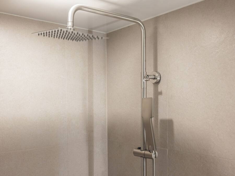 A shower with a curved head and a handheld showerhead.