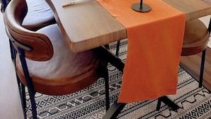 A dining area with a wooden table, chairs, a potted plant, and two lamps. - Spacious 2BR Feltham Home Sleeps 5 (Feltham)