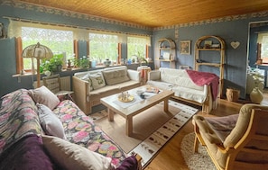 A cozy living room with a sofa, armchair, and a coffee table. - 3 bedroom beautiful home in Sjötofta (Sjötofta)