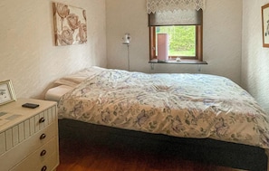 A bedroom with a bed, dresser, window, and artwork on the wall. - 3 bedroom beautiful home in Sjötofta (Sjötofta)