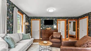 A living room with a sofa, two armchairs, a coffee table, a television, and a wooden cabinet. - Four Lanterns - NEW! 4 Houses in Blue Hill (Blue Hill)