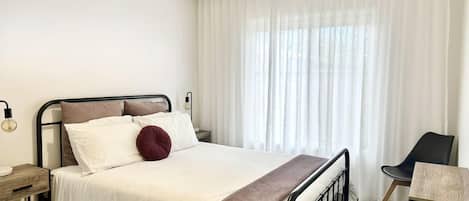 Apartment, 2 Bedrooms | Laptop workspace, blackout drapes, iron/ironing board, travel crib