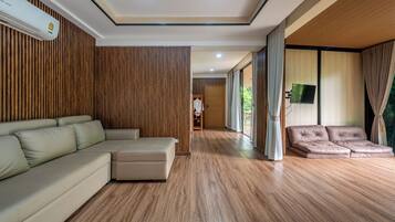 Villa Suite | Living area | 32-inch TV with cable channels