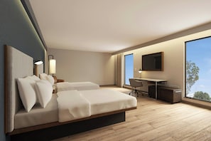 Una habitación de hotel moderna con cama, escritorio y ventana grande.