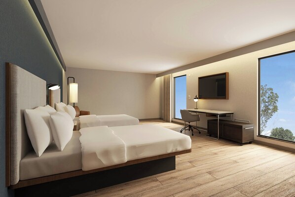 Une chambre d’hôtel moderne, équipée d’un lit, d’un bureau et d’une grande fenêtre.