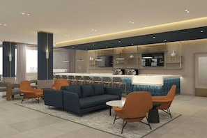 A modern hotel lobby with a sofa, chairs, a small table, and a kitchen area with a bar. - Courtyard by Marriott Torreón (Torreón)