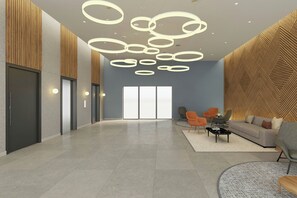 A spacious lobby with a modern design, featuring a large seating area, a reception desk, and a patterned wall. - Courtyard by Marriott Torreón (Torreón)