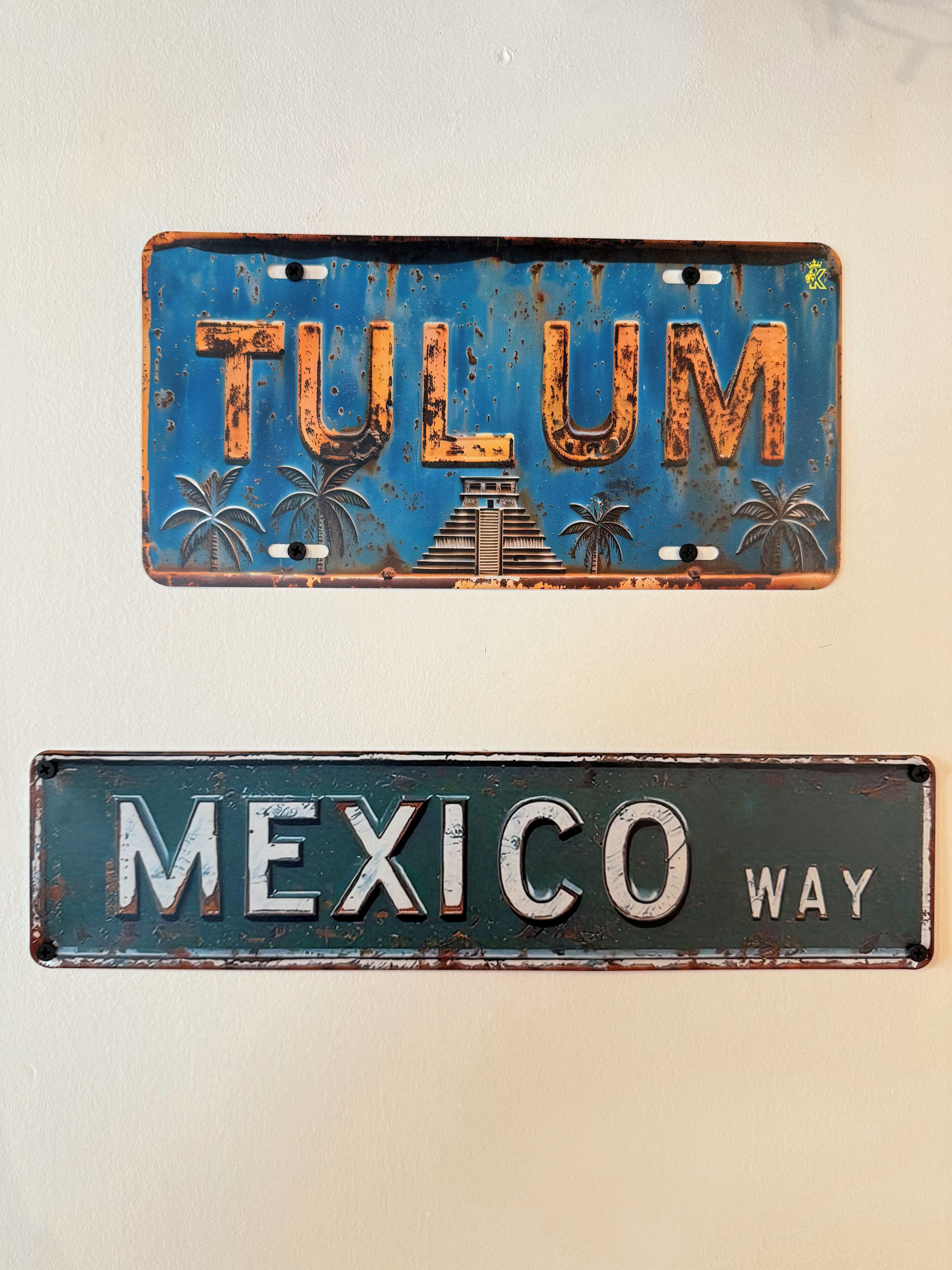 Two vintage license plates, one with 'TULUM' and the other with 'MEXICO WAY'.