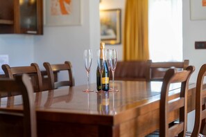 A dining table with a bottle of wine and three wine glasses. - Villa Casa Rita (100601-K1) - Porec (Porec)