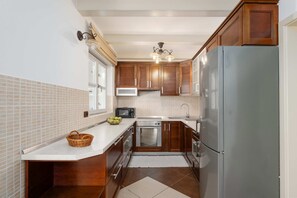 A kitchen with wooden cabinets, a stainless steel refrigerator, a microwave, and a dishwasher. - Villa Casa Rita (100601-K1) - Porec (Porec)