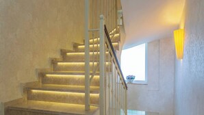 A staircase with a handrail and a window with a plant. - Premium 4 bedroom villa in Oludeniz (Fethiye)