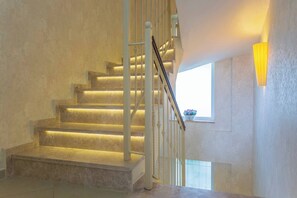 A staircase with a handrail and a window with a plant. - Premium 4 bedroom villa in Oludeniz (Fethiye)
