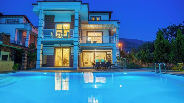 A two-story building with a swimming pool in front. - Premium 4 bedroom villa in Oludeniz (Fethiye)