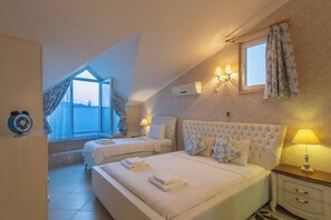 A bedroom with two beds, a window with curtains, a wall-mounted air conditioner, and bedside lamps. - Premium 4 bedroom villa in Oludeniz (Fethiye)