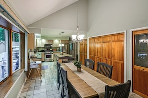 A spacious kitchen with a dining area, wooden cabinets, and a large island. - Pool & Marina Access, Game Room: Lewes Family Home (Lewes)