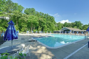 A swimming pool with lounge chairs and umbrellas, surrounded by trees. - Pool & Marina Access, Game Room: Lewes Family Home (Lewes)