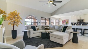 A modern living room with a sectional sofa, a coffee table, and a potted plant. - Mtn-View Fountain Hills Oasis w/ Private Pool! (Fountain Hills)