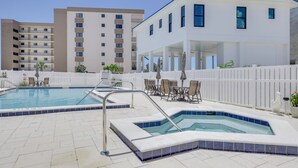 A swimming pool with a hot tub, lounge chairs, and a white fence. - Gulf-Front Gem w/ Pool Access on Fort Myers Beach! (Fort Myers Beach)