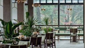 A spacious indoor area with a high ceiling, large windows, and multiple seating arrangements. - ALOR VALLEY HUZHOU (Huzhou)