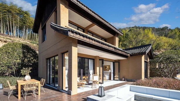 A modern two-story house with large windows, a wooden deck, and a traditional roof. - ALOR VALLEY HUZHOU (Huzhou)